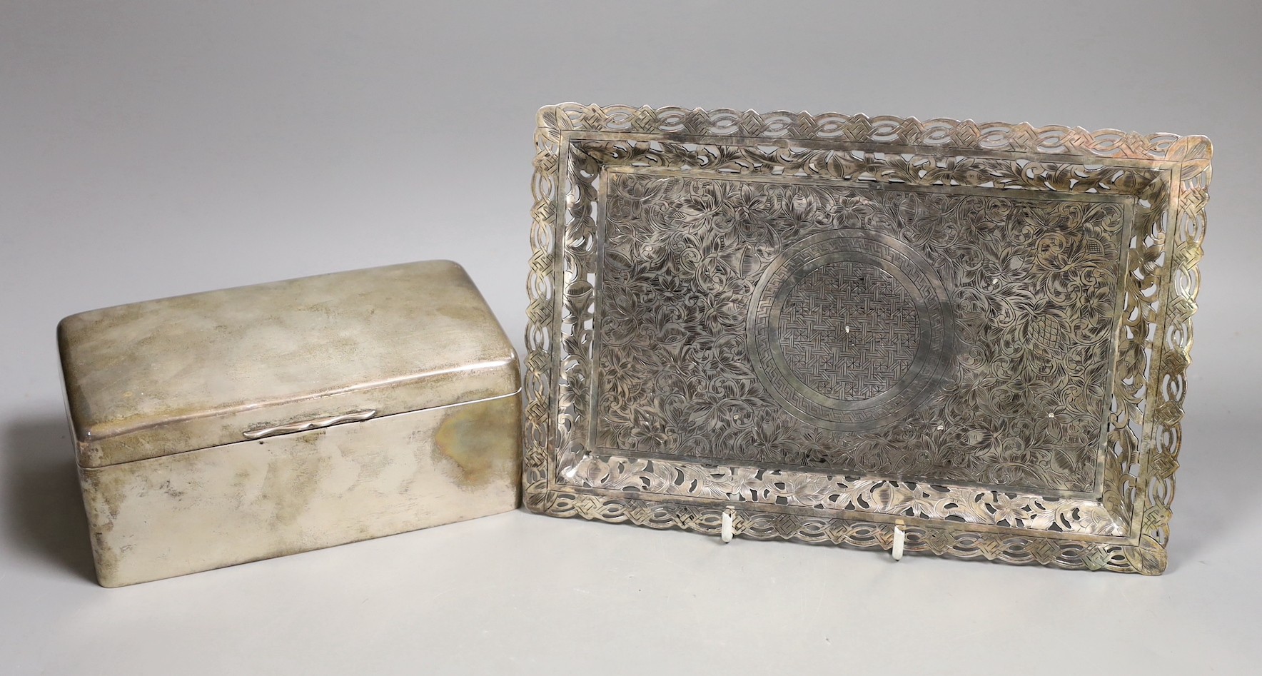 A George V silver mounted rectangular cigarette box, Birmingham, 1911, 17.2cm and an engraved white metal small tray.